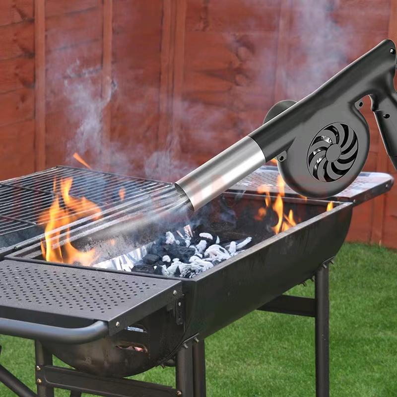 Huntar Cordless BBQ Turbo Blower in action, effectively igniting flames on a charcoal grill outdoors.