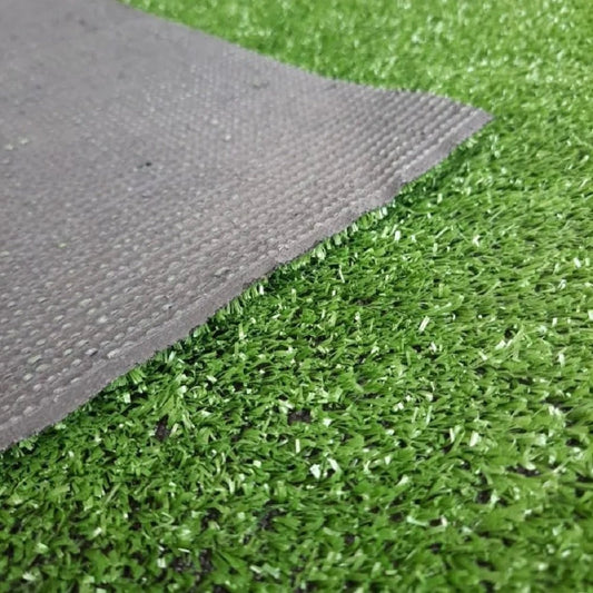 Close-up view of the Grass Artificial Carpet 10mm, showcasing the realistic green blades and textured backing of the 4M x 25M carpet, perfect for enhancing outdoor spaces.