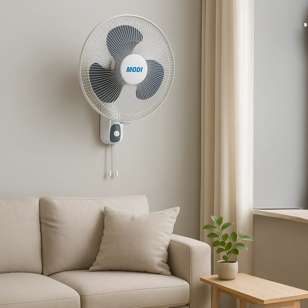 16-inch Wall Fan mounted on a wall beside a cozy sofa, perfect cooling solution for indoor spaces.