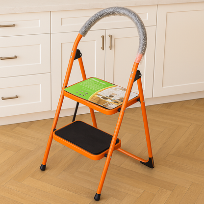 Heavy-Duty Ladder 2-Step by SOMA positioned in a modern kitchen, showcasing its vibrant orange color and sturdy construction, perfect for home and workshop use.