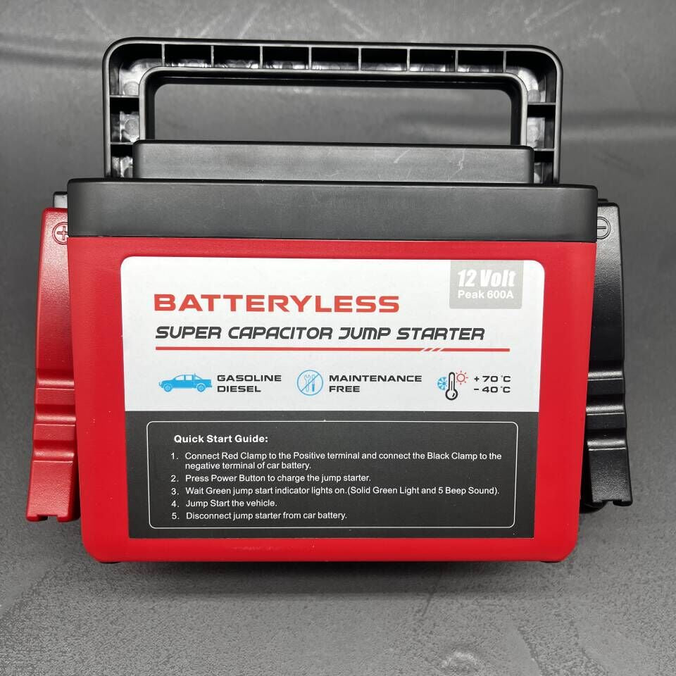Red and black batteryless super capacitor jump starter on a gray background