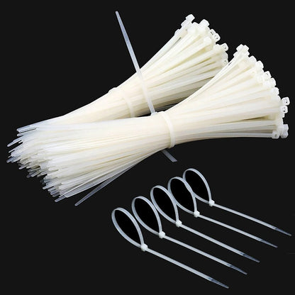 Cable Tie White – Bundles of durable white cable ties, ideal for optimizing workspace and managing cables seamlessly.